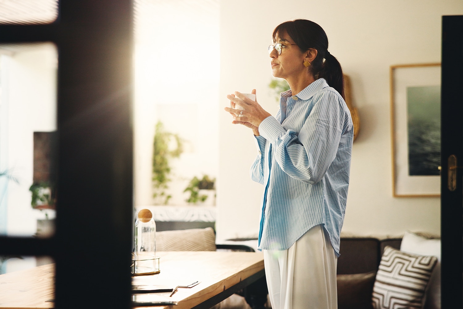 Woman holding coffee mug at home